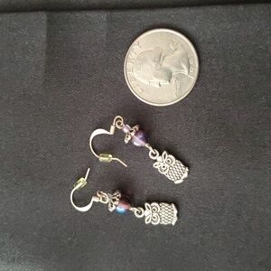 Silver tone owl earrings with an iridescent bead